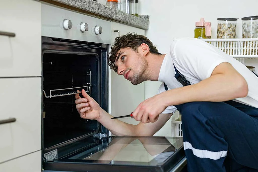 Technician inspecting the inside of a residential oven